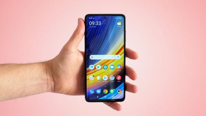 A Xiaomi Poco X3 Pro in someone's hand, with the screen on